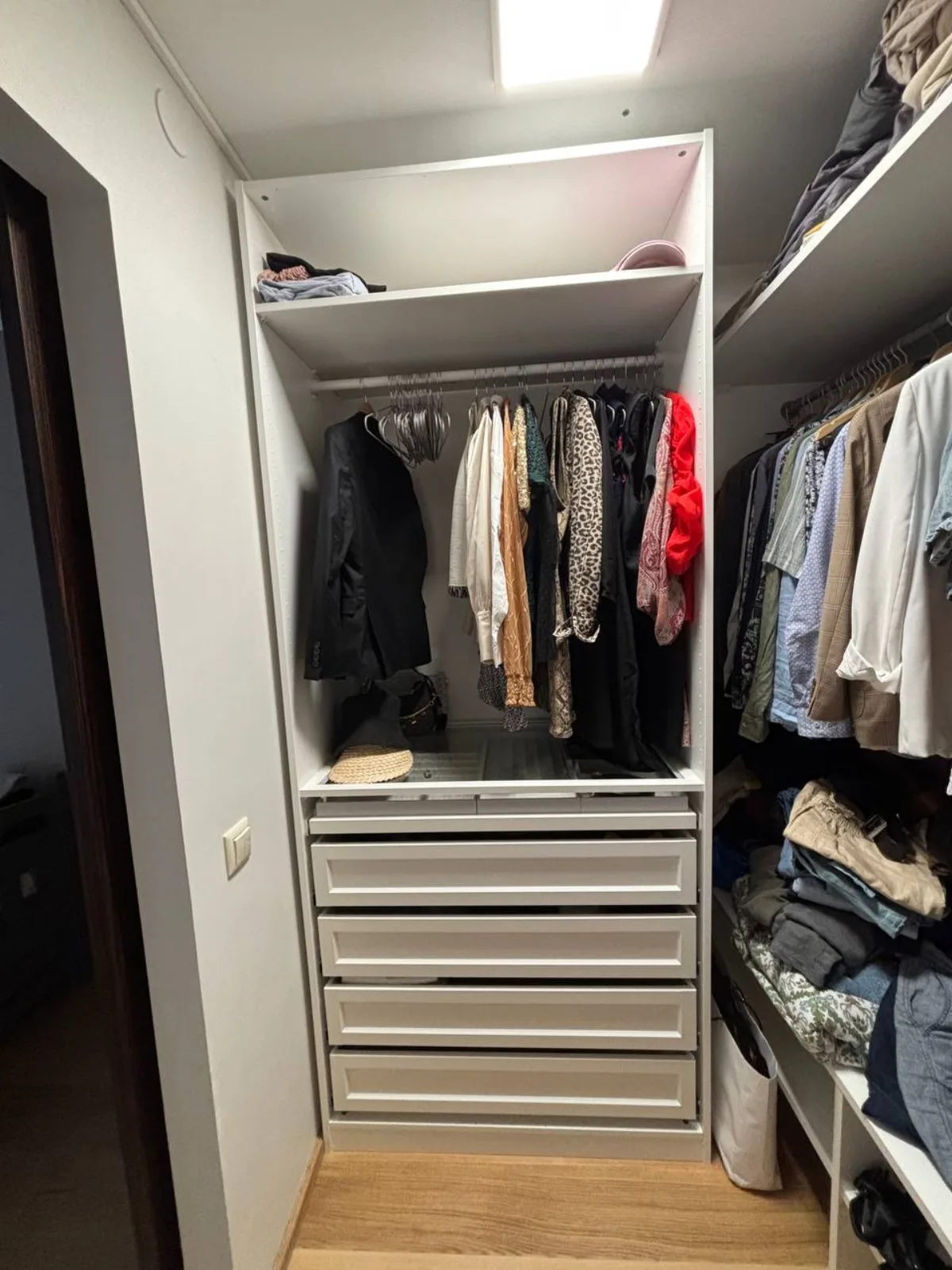 Open wardrobe with a shelf, hanging rail and drawers