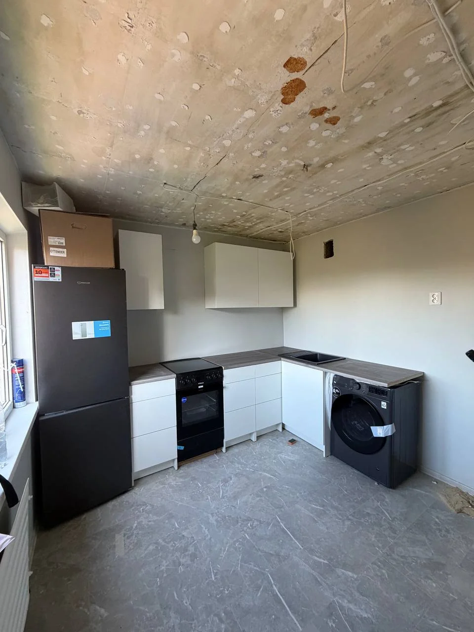 IKEA corner kitchen with white base and wall cabinets